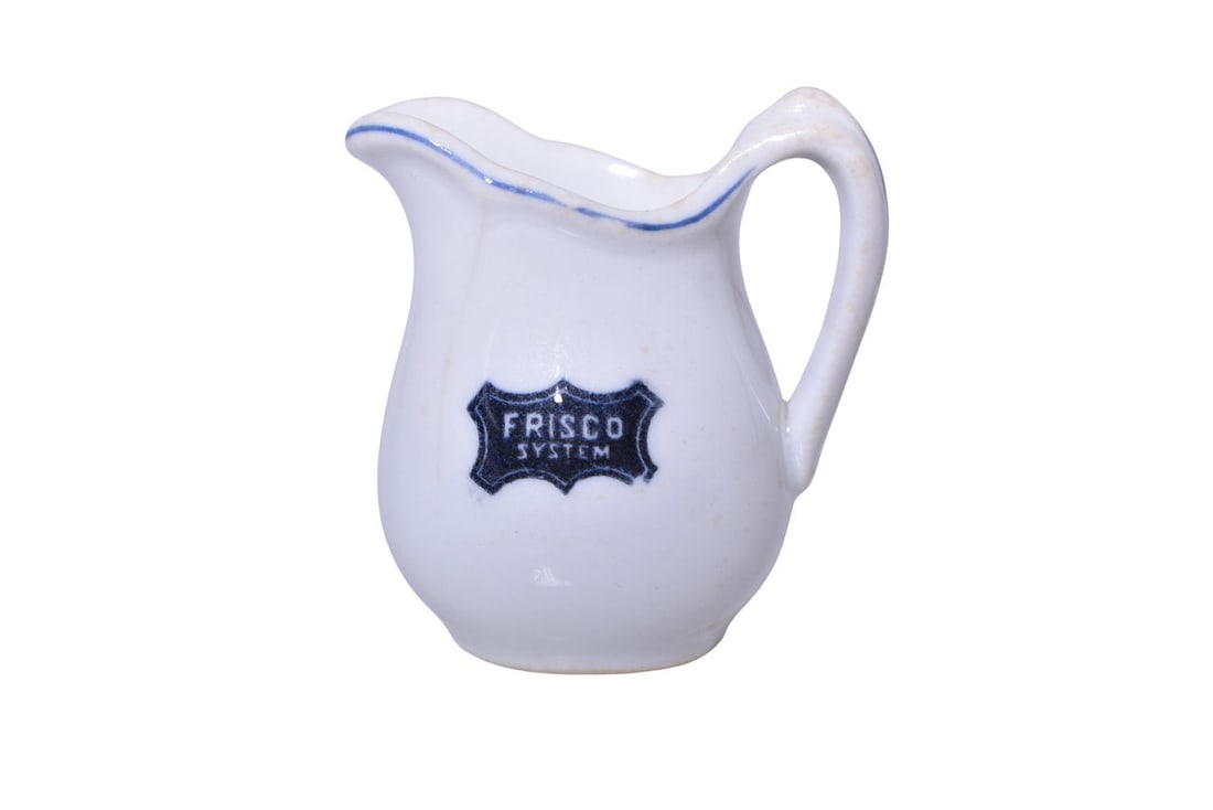St. Louis San Francisco Railroad Frisco System China Creamer: A small 2 3/4" tall cream pitcher for the St. Louis San Francisco Railroad in the Frisco pattern, side marked with the Frisco System logo. This pattern dates to the turn of the century. The creamer sh