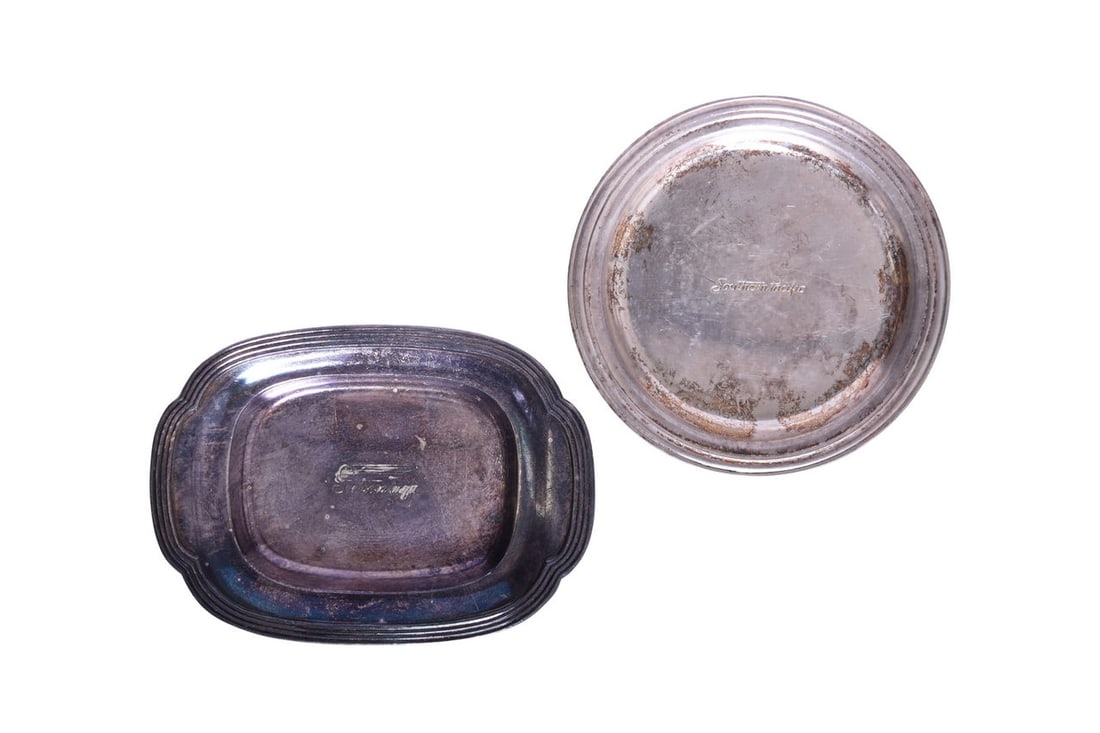 Pair of Southern Pacific Railroad Silver Butter Pats: Includes a 4 1/8" by 3" butter pat top marked with the Southern Pacific Daylight logo by Reed & Barton 3300 with a scales date icon. A 3 1/2" round butter pat top marked Southern Pacific in cursive by