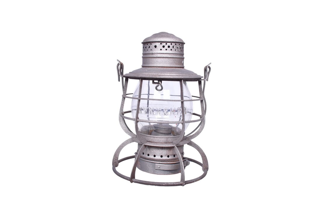 Railroad Signal Lamp & Lantern Co. New York, New Haven & Hartford Railroad Lantern: R.R. Signal Lamp & Lantern Co. lantern with NYNH&H RR embossed on the shoulder. Lantern stands straight with moderate pitting throughout, plus a couple small dents in the chimney. The underside of the