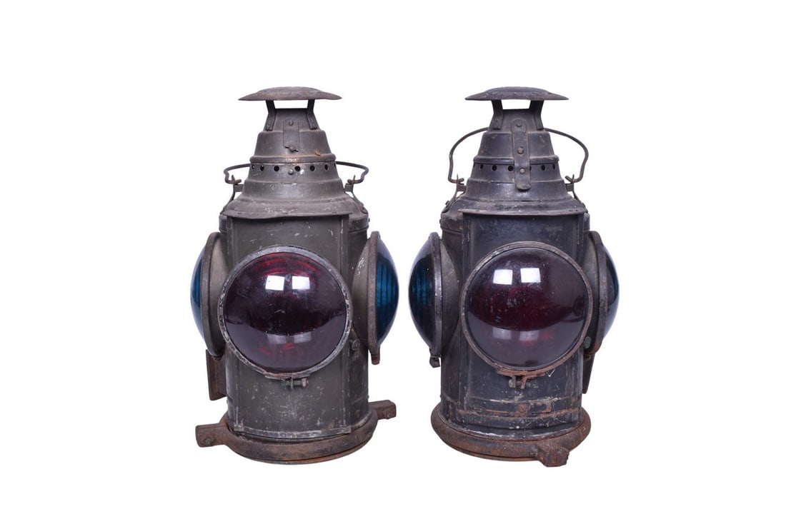 Pair of Dressel Railroad Caboose Marker Lamps: Dressel railroad switch lamps are unrestored with mild surface rust and small spots of paint loss. One has more moderate rust on mount bracket and red lens retainer ring. One's door is rusted shut but