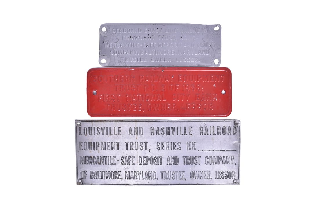 Three Railroad Trust Plates - Seaboard Coast Line, Southern, Louisville & Nashville: This collection of three metal signs include: 14 1/2" x 5" Seaboard Coast No. 6, with metallic silver paint. Face shows evidence of wear and corrosion near the mounting holes, with one broken corner. 