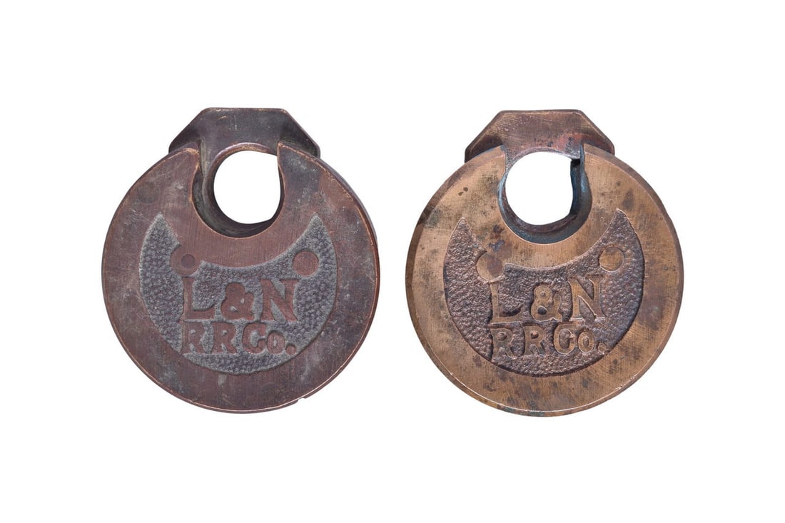 Pair of Louisville and Nashville Railroad Pancake Six Lever Brass Locks: Two brass six lever pancake locks, each cast with L&N RR Co. on the front over a pebbled background. No manufacturer marks. Keys for both locks are missing. Locks have mild wear, including some small 