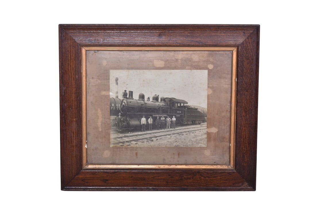 New York Central & Hudson River Railroad Locomotive # 164 Framed Photo: Framed 13 1/4" by 10 1/2" photo of steam locomotive number 164, marked for both New York Central Lines and NYC & HR on the coal car. Frame measures roughly 27" by 23". The builder's plate is visible i
