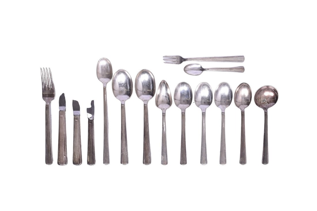 Fifteen Pieces of New York Central Lines Dining Car Silverware - Soda Spoons, Oyster Forks, etc.: This collection of silverware is all bottom stamped "International Silver" and each piece bears the "NYC" logo of the New York Central Lines. The group shows moderate wear with nicks and scuffs presen
