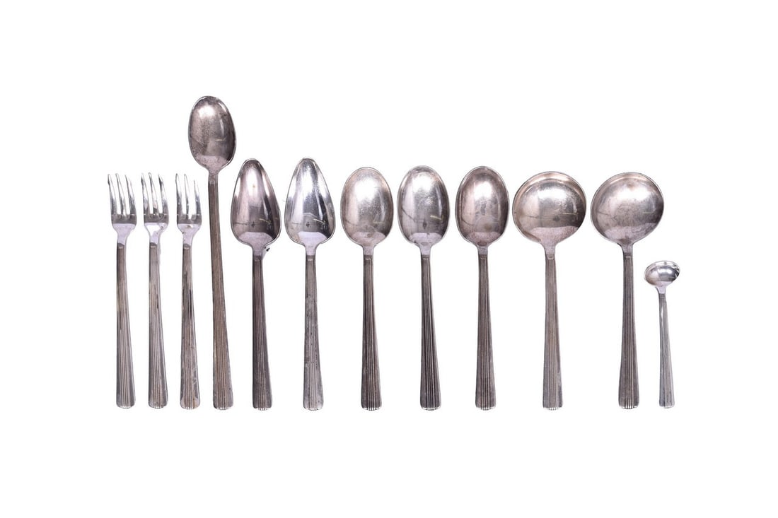 Twelve Pieces of New York Central Lines Dining Car Silverware - Gravy Spoon, Oyster Fork, etc.: This collection of silverware is all bottom stamped "International Silver" and each piece bears the "NYC" logo of the New York Central Lines. Group includes: One 3-1/2" gravy spoon, two 6-1/4" salad s