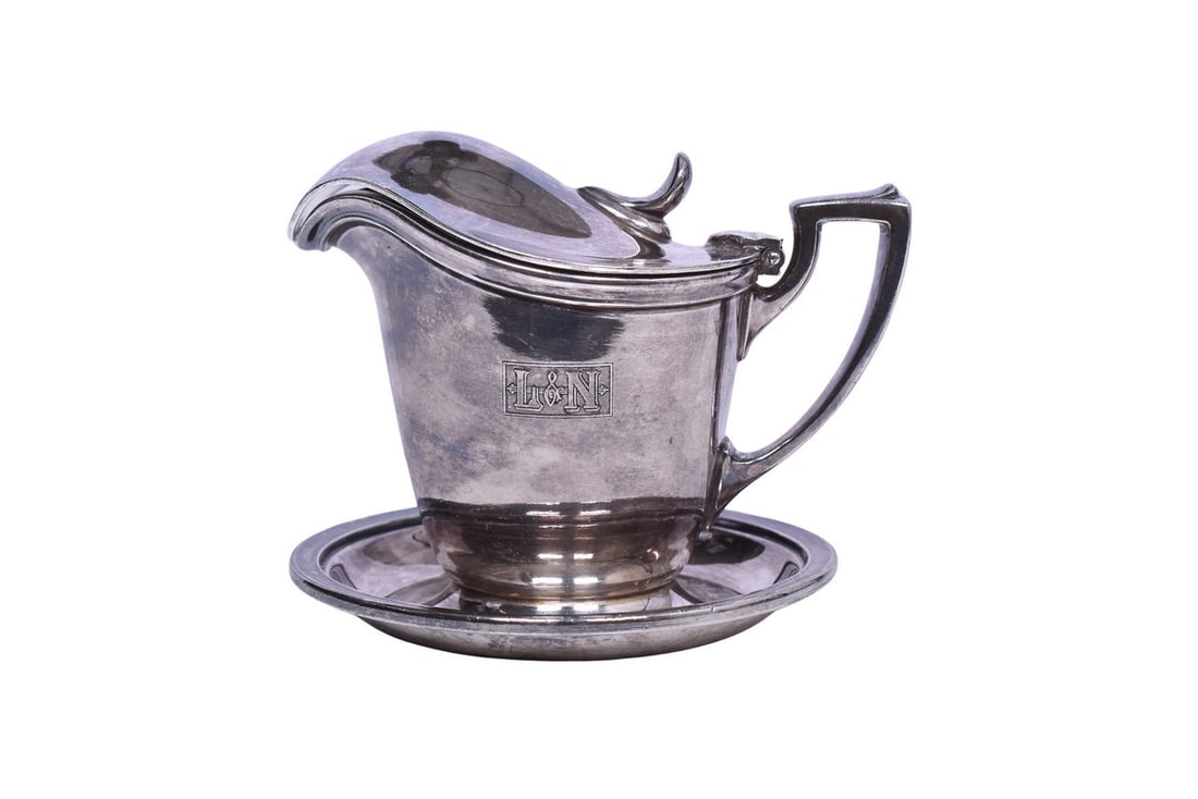 International Silver Louisville and Nashville Railroad Cream Pitcher w/ Attached Underliner: A dining car silver creamer or syrup pitcher with hinged lid and attached under-liner for Louisville and Nashville Railroad, side marked with L&N box logo, and bottom stamped International Silver Co. 