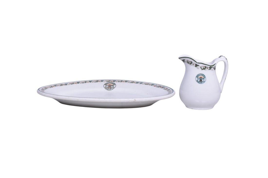 Southern Pacific Railroad China Sunset Cream Pitcher and Oval Platter Plate: Pair of dining car china items for the Southern Pacific Lines in the Sunset pattern. Includes a 3 1/2" tall creamer showing a 1 1/2" glaze crack with discoloration on the back, scratches with glaze we