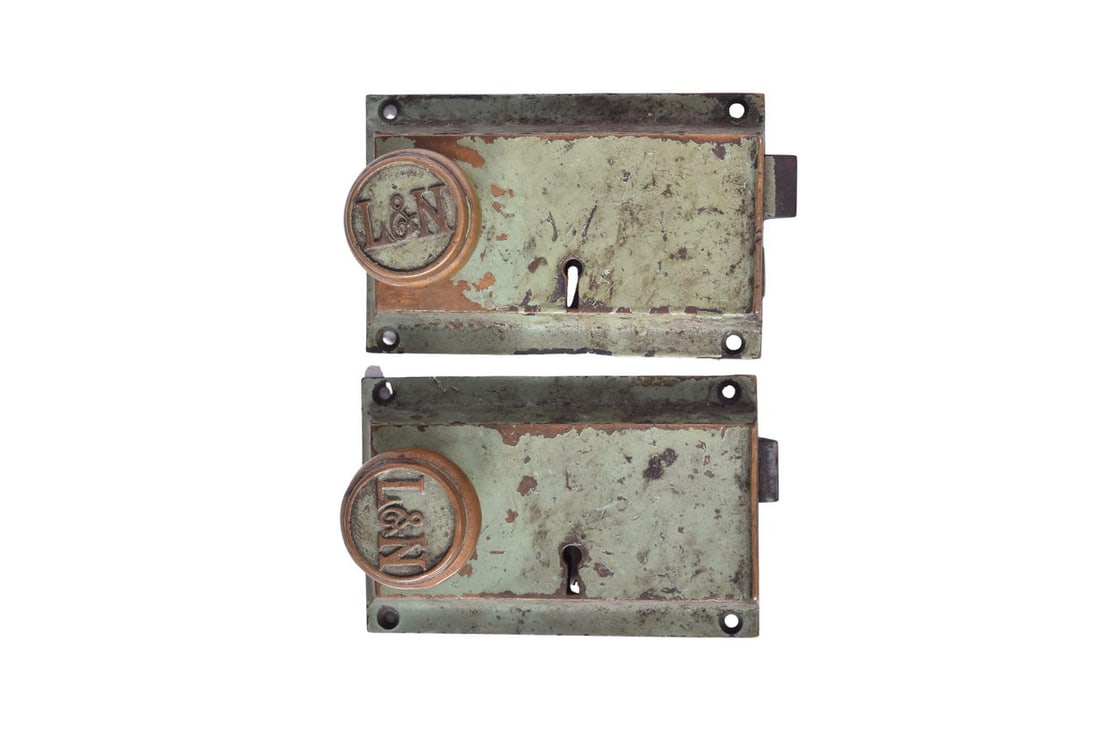 Pair of Louisville and Nashville Railroad Brass Door Lock Sets: Twin original railcar door locks from the Louisville and Nashville Railroad. Each green painted brass lock measures roughly 6 1/2" by 4", and has a brass L&N cast door handle. Knobs on both locks