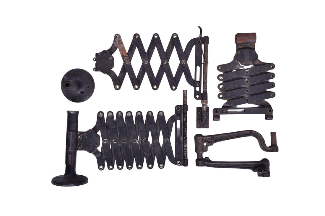Four Desk Mount Arms - Telegraph Equipment: Roughly four desk mount arms likely for use with telegraph or similar equipment. Includes three extending scissor-style mounts and one cast iron mount similar to the J.H. Bunnell sounder box style.