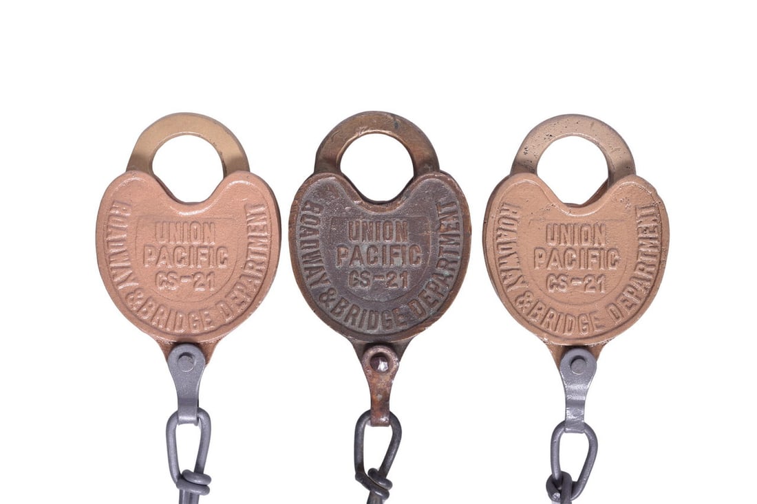Three Union Pacific Roadway & Bridge Department Brass Heart Shaped Locks with Keys: Three locks, all heart shaped and cast with Union Pacific Roadway & Bridge Department on them. Two are marked CS-21 and are painted, the third appears to be marked GS-21. The GS-21 lock does not have