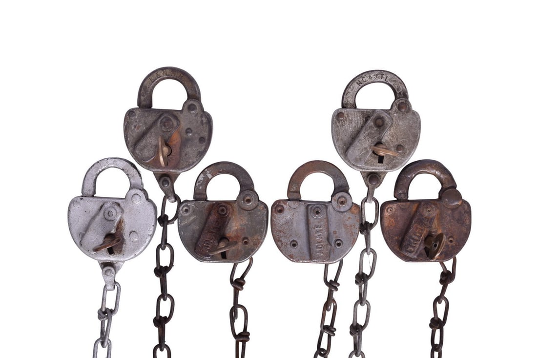 Six Steel-Bodied Railroad Locks and Keys - Louisville and Nashville, Florida East Coast, Central of: Six steel-bodied locks: three stamped L&N RR, one with NC&STL on the shackle, one with FEC RY on front of the body, and one with C OF GA on the front. All but the Florida East Coast lock have their