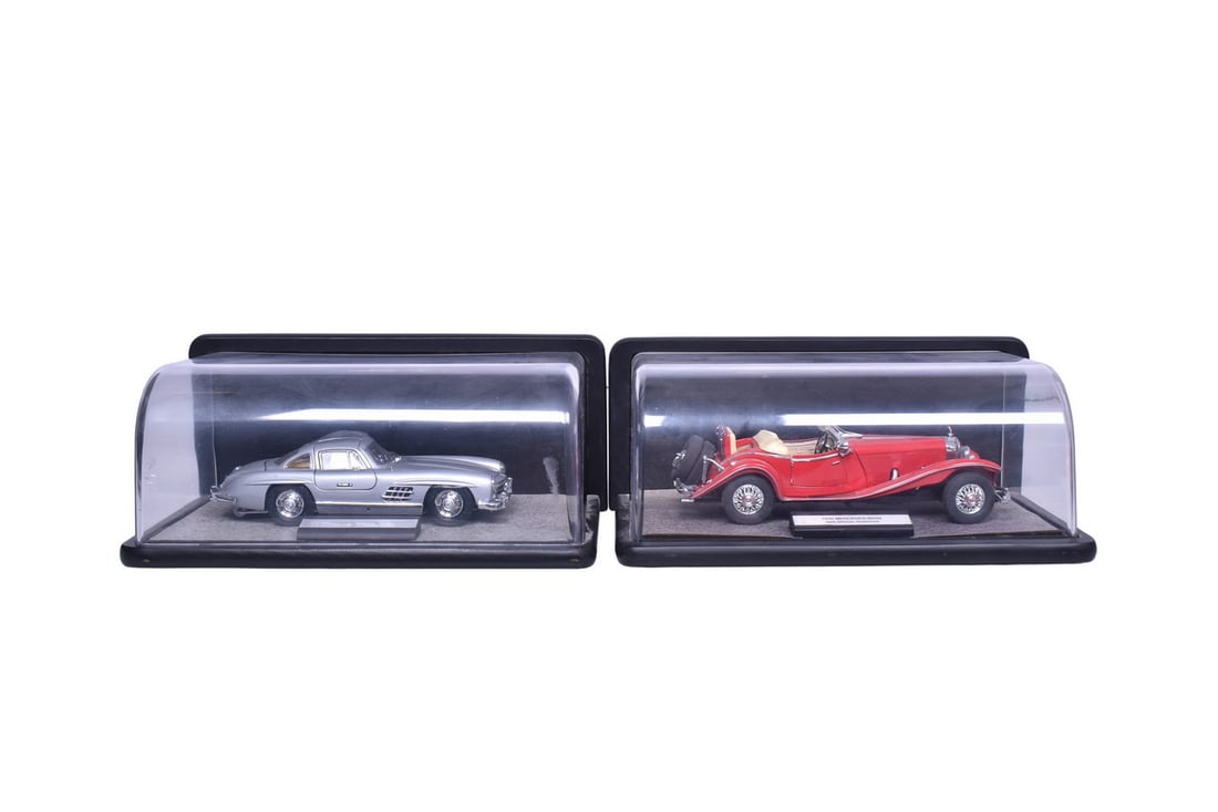 Two Franklin Mint 1:24 scale diecast Mercedes-Benz models, one a 500K from 1935 and one a 300SL from: Two Franklin Mint 1:24 scale diecast Mercedes-Benz models, one a 500K from 1935 and one a 300SL from 1954. Each comes with its original wood and plastic display case, 1935 model has a bent front bumpe