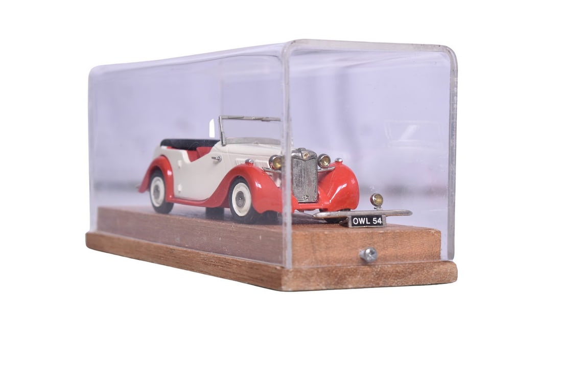 RAE 1:43 white metal die cast 1950 MG Y type. Car is presented in a wooden display case and is in: RAE 1:43 white metal die cast 1950 MG Y type. Car is presented in a wooden display case and is in very good condition with the exception of a detached mirror which is in the display case.