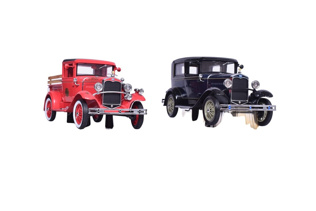 Two 1:18 scale Motor City Classics models of the 1931 Ford Model A, one in all black and one fire: Two 1:18 scale Motor City Classics models of the 1931 Ford Model A, one in all black and one fire chief red. Cars come with original display platforms, good condition with no missing pieces or damage.