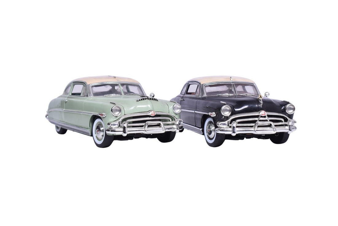 Two Hudson Hornet models, both by Die Cast Promotions, one in black and cream, the other in mint: Two Hudson Hornet models, both by Die Cast Promotions, one in black and cream, the other in mint green and cream. Both have broken radio antenna, and are otherwise in good shape.