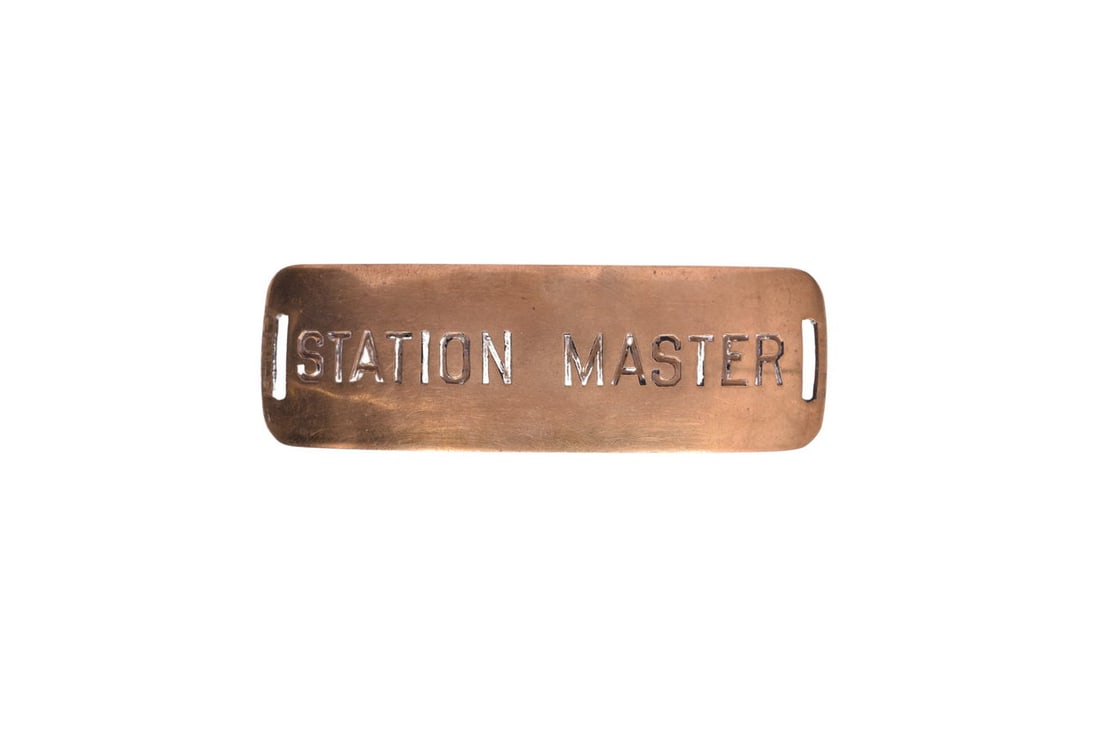 A brass Station Master uniform cap badge measuring 3 5/16" and showing light scratches and light