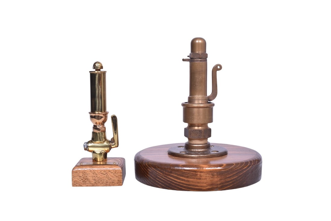 Two brass peanut whistles, each mounted its own wooden base for display. The 6 1/8" tall whistle (1 of 5)