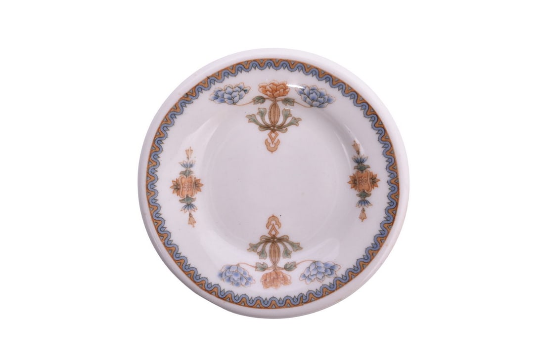 A 3 3/8" diameter butter pat for the Louisville and Nashville Railroad in the Regent pattern, bottom: A 3 3/8" diameter butter pat for the Louisville and Nashville Railroad in the Regent pattern, bottom marked Old Ivory Syracuse China O.P.CO. Regent 21, showing minimal use with light scratches on the 