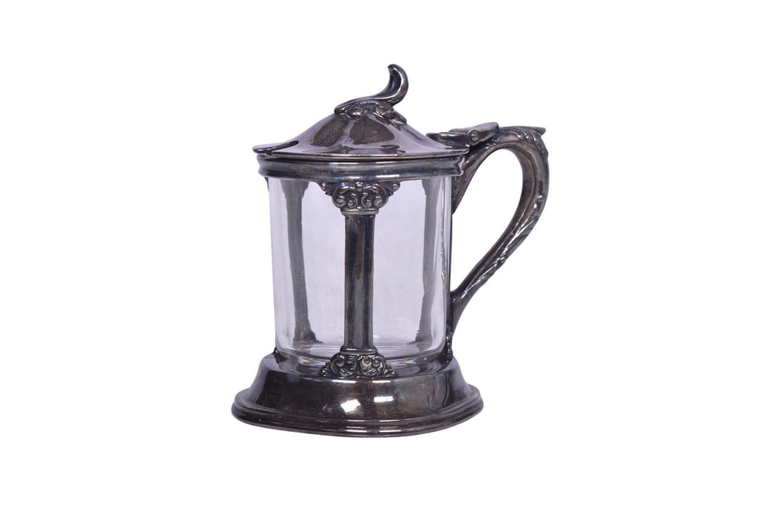 A 3 3/4" tall mustard pot with glass insert and decorative handle, sides, and lid. Bottom stamped: A 3 3/4" tall mustard pot with glass insert and decorative handle, sides, and lid. Bottom stamped Reed & Barton Silver Soldered B&O 102 6. Silver shows moderate tarnish all over. No chips, cra