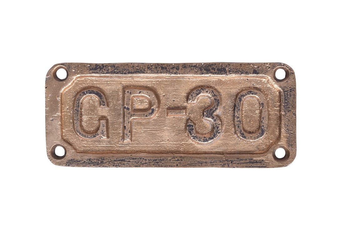 6 1/2" by 2 3/4" cast brass plate reading GP-30. Mild wear and residual black paint on the front,