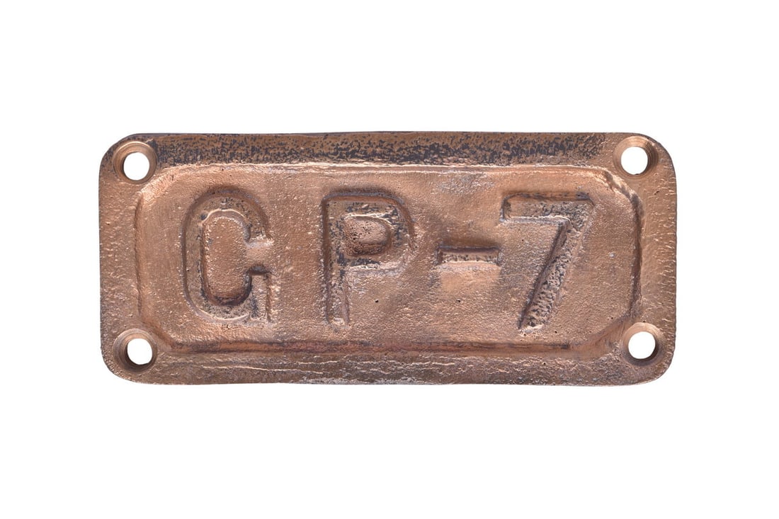 6 3/8" by 2 7/8" cast brass plate reading GP-7. Mild pitting and residual black paint on the front. (1 of 2)