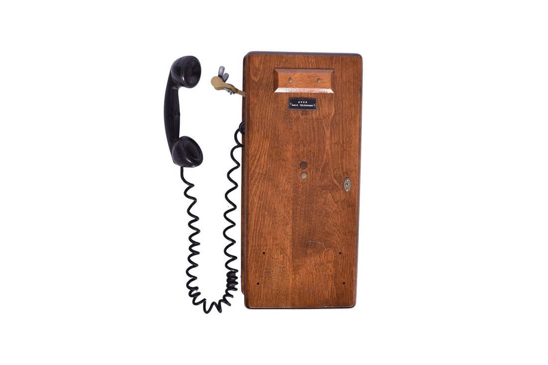 A 20 1/2" x 9 1/4" x 6" oak wood wall mounted telephone. The front displays the original "U.P.R.R. (1 of 5)