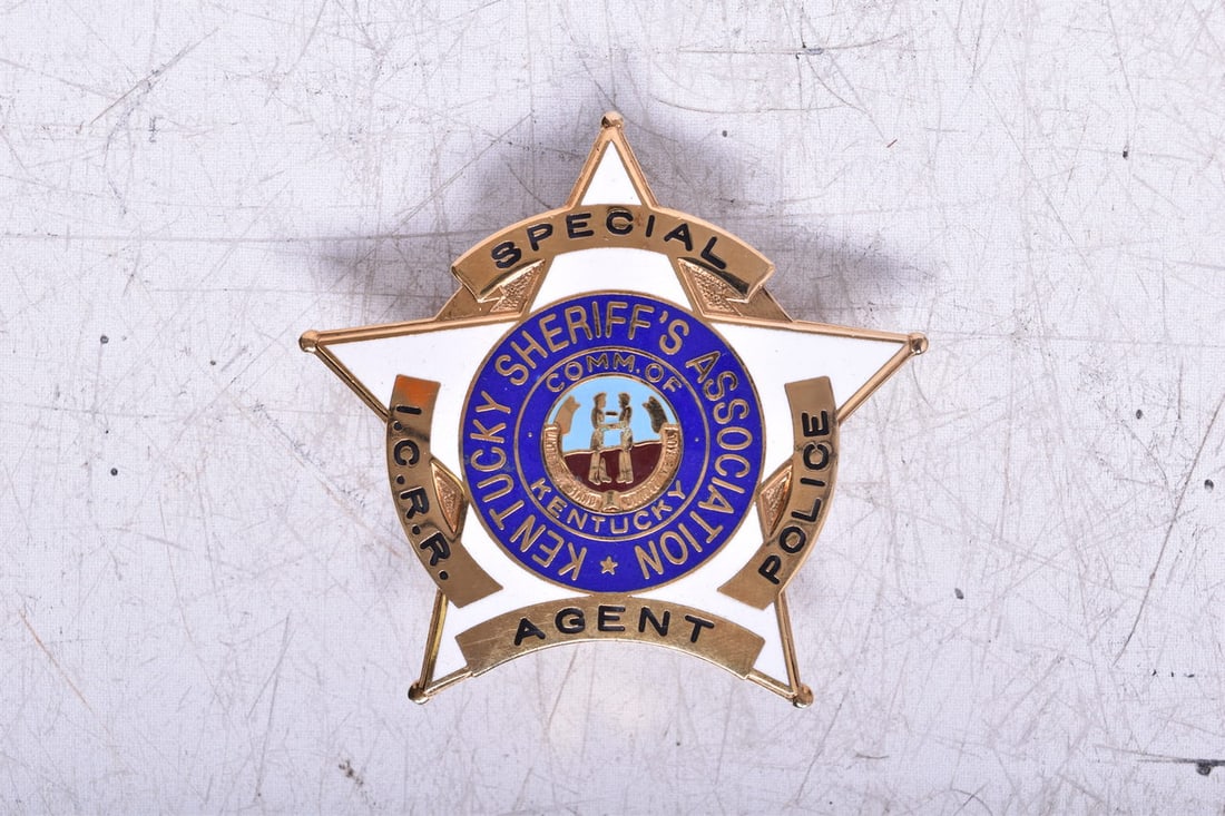 A pin back five point star brass and enamel police badge with black and brass enamel lettering. It: A pin back five point star brass and enamel police badge with black and brass enamel lettering. It reads I.C.R.R. Special Agent Police Kentucky Sheriff's Association Comm. of Kentucky. Enamel is in go