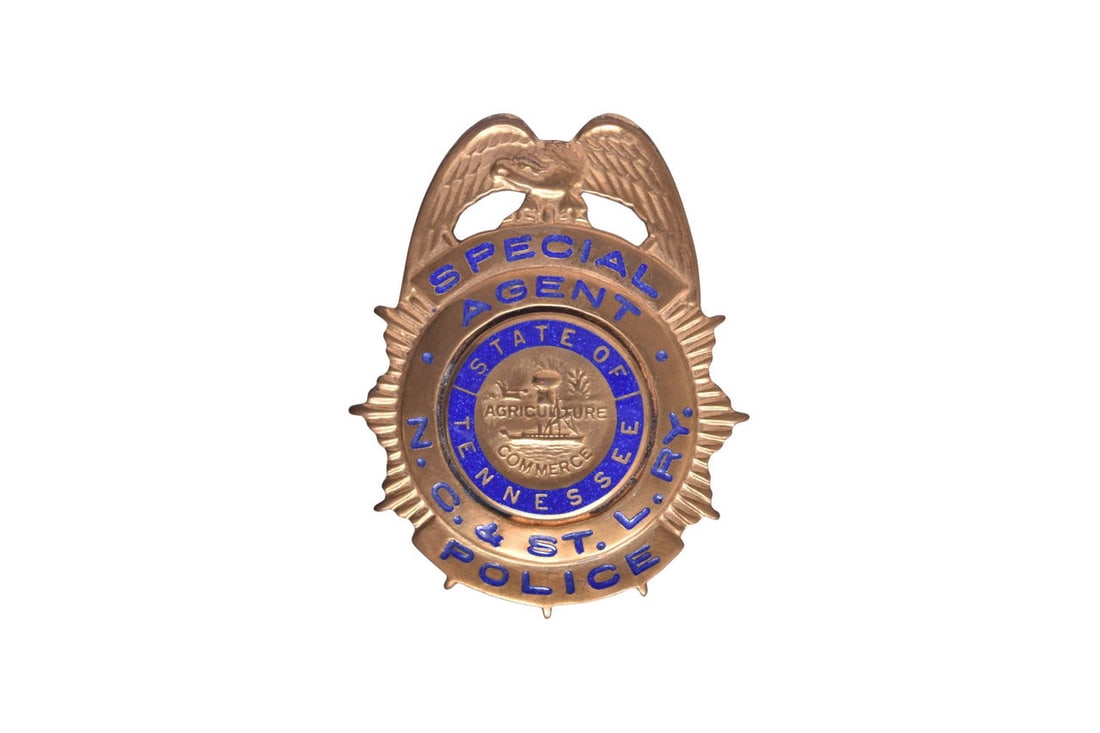 Pin back brass badge with Special Agent NC& ST. L Ry Police in blue enamel lettering. There is (1 of 2)