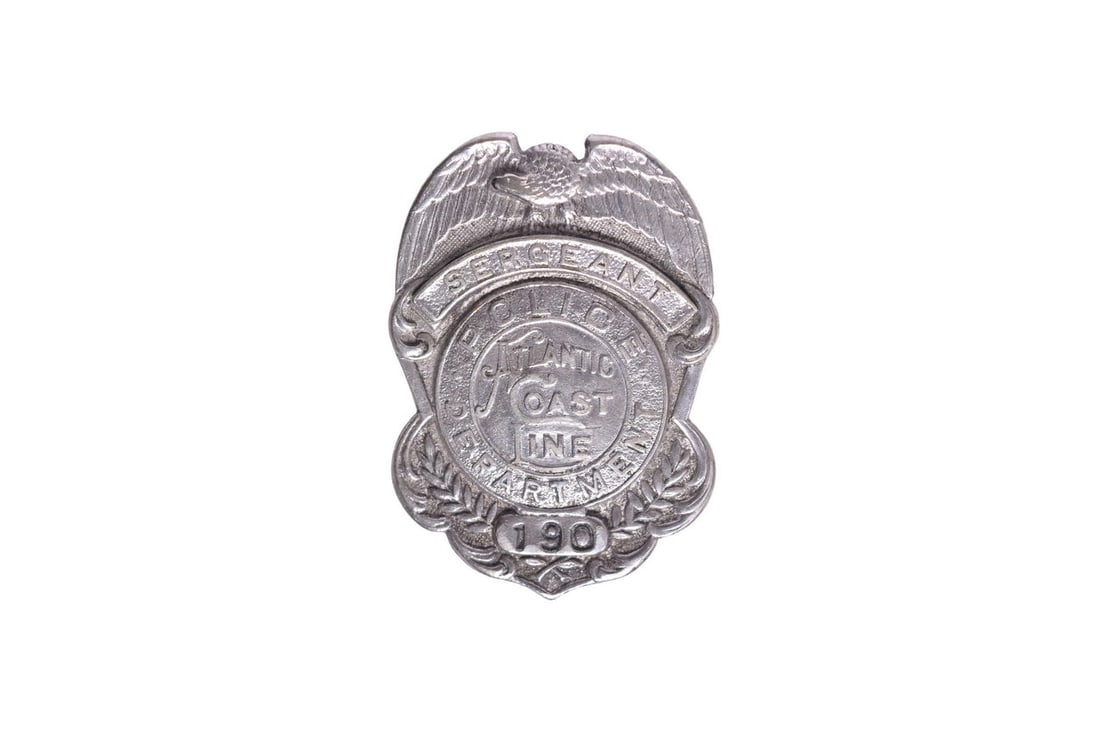 Pin back nickel plated police sergeant badge for the Atlantic Coast Line, number 190. Small spot of: Pin back nickel plated police sergeant badge for the Atlantic Coast Line, number 190. Small spot of wear below and left of the Sergeant banner; otherwise good condition with intact pin. See photos for