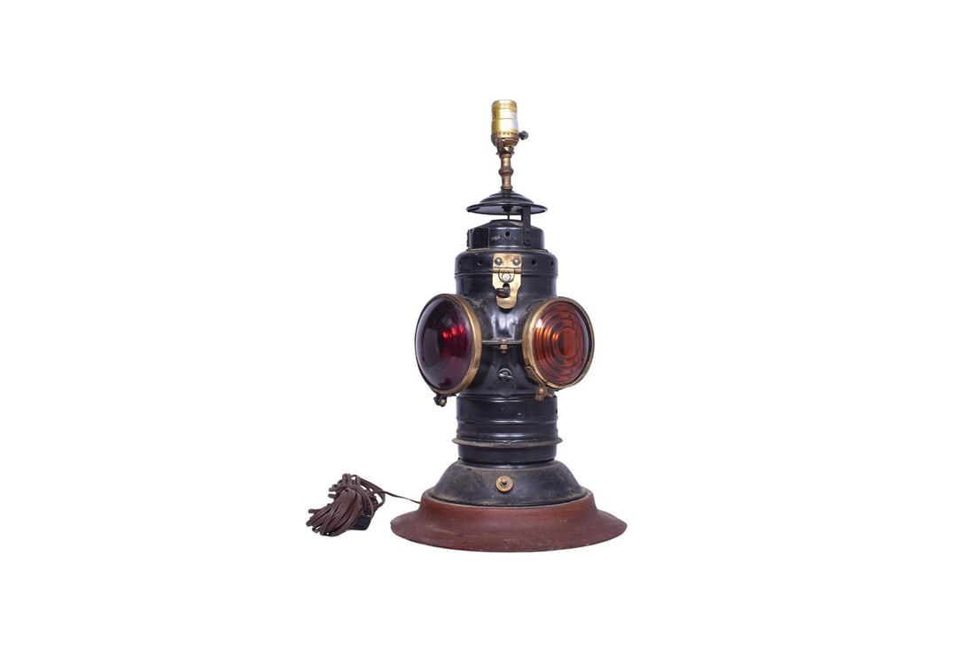 Armspear bell bottom switch lamp that has been converted to an electrified table lamp. The lamp is: Armspear bell bottom switch lamp that has been converted to an electrified table lamp. The lamp is attached to a wooden base and has been modified with a hole for a switch along the bottom of the body