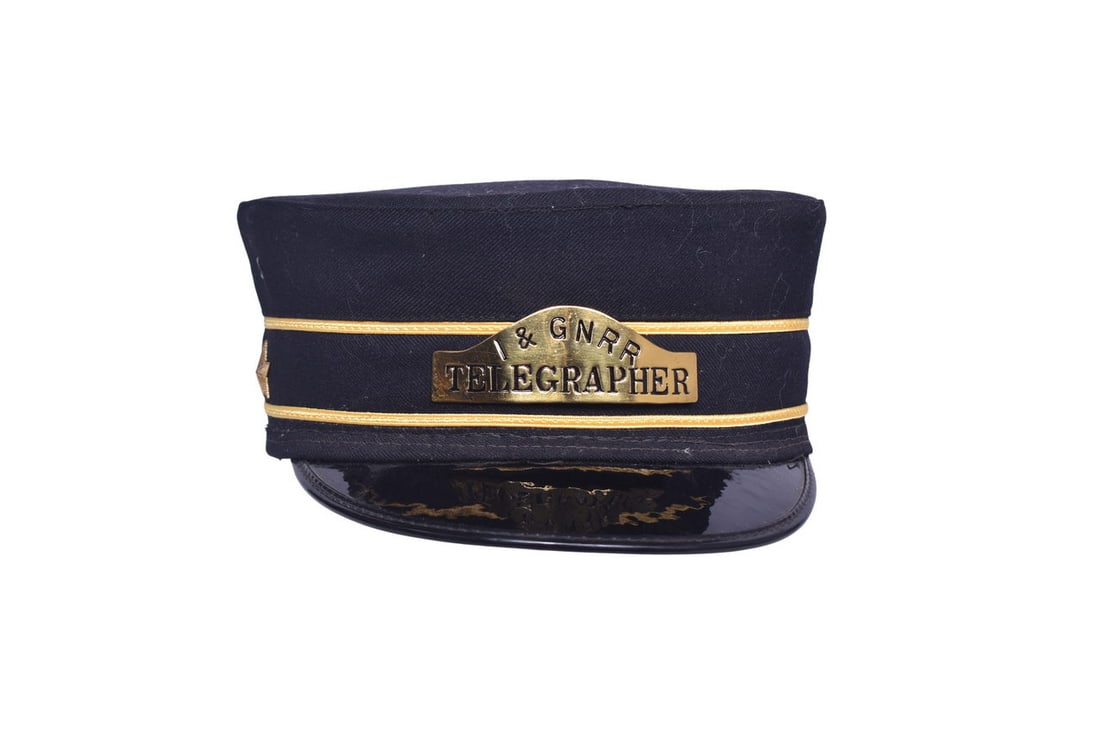 A railroad uniform cap with a I&GN RR Telegrapher brass badge and two brass stars, one on either (1 of 5)