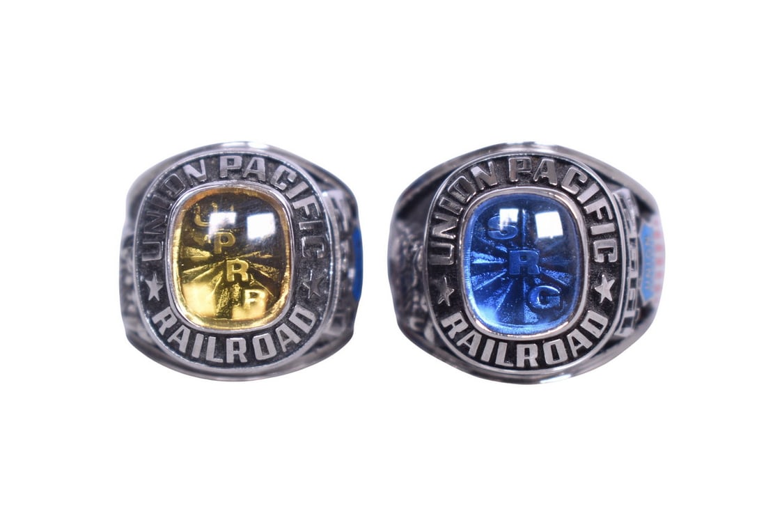 Two JLS brand men's railroad service rings, one with a yellow stone and one with a blue stone. Both (1 of 6)