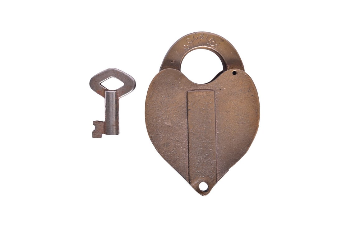 Heart-shaped brass lock with C.C.C. & I R R stamped on the shackle. The reverse of the shackle: Heart-shaped brass lock with C.C.C. & I R R stamped on the shackle. The reverse of the shackle is stamped W. Bohannan Brooklyn N. Pat'd June 25. 78. 115 C. Lock has some mild pitting and wear, suc