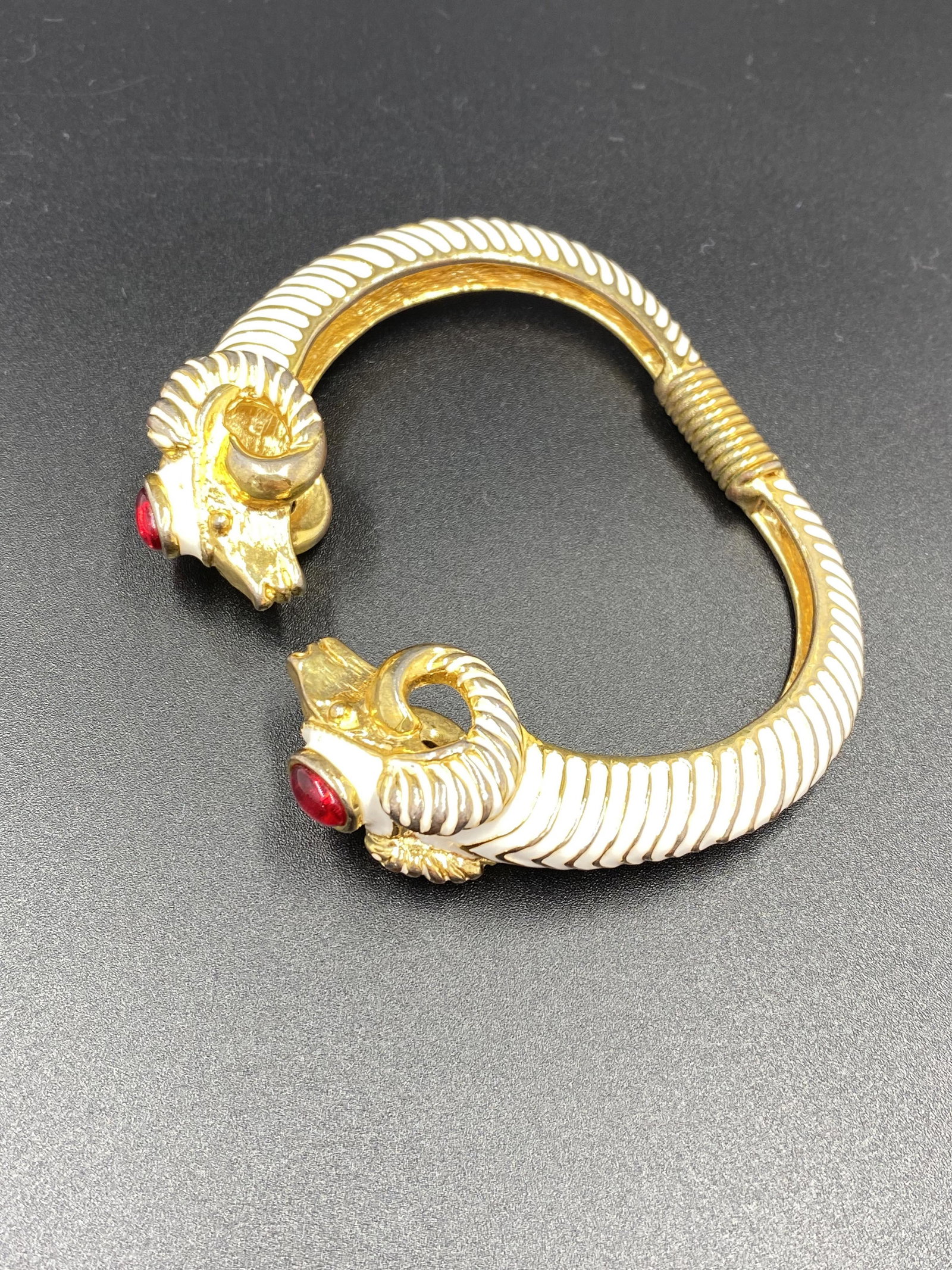 Kenneth Jay Lane KJL Ram Heads Hinged Bracelet: Marked KJL. For exact dimensions please refer to the attached dimensions sheet. Innovative, gifted, and imaginative, Kenneth Jay Lane's exceptional skill has ensured him a permanent place in fashion h