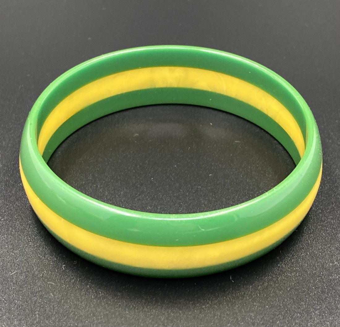 BAKELITE 3-Row Laminated Bangle Yellow & Green: For exact dimensions please refer to the attached dimensions sheet. Bakelite was an early plastic resin, developed by Leo Baekeland in 1907. Originally used for industrial purposes thanks to its abili