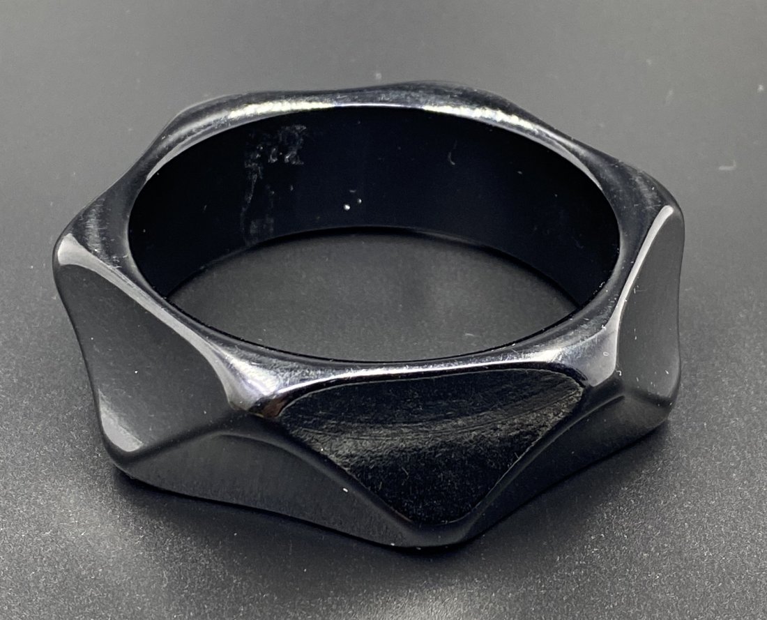 Bakelite Black Triangle Faceted Bangle: For exact dimensions please refer to the attached dimensions sheet. Bakelite was an early plastic resin, developed by Leo Baekeland in 1907. Originally used for industrial purposes thanks to its abili