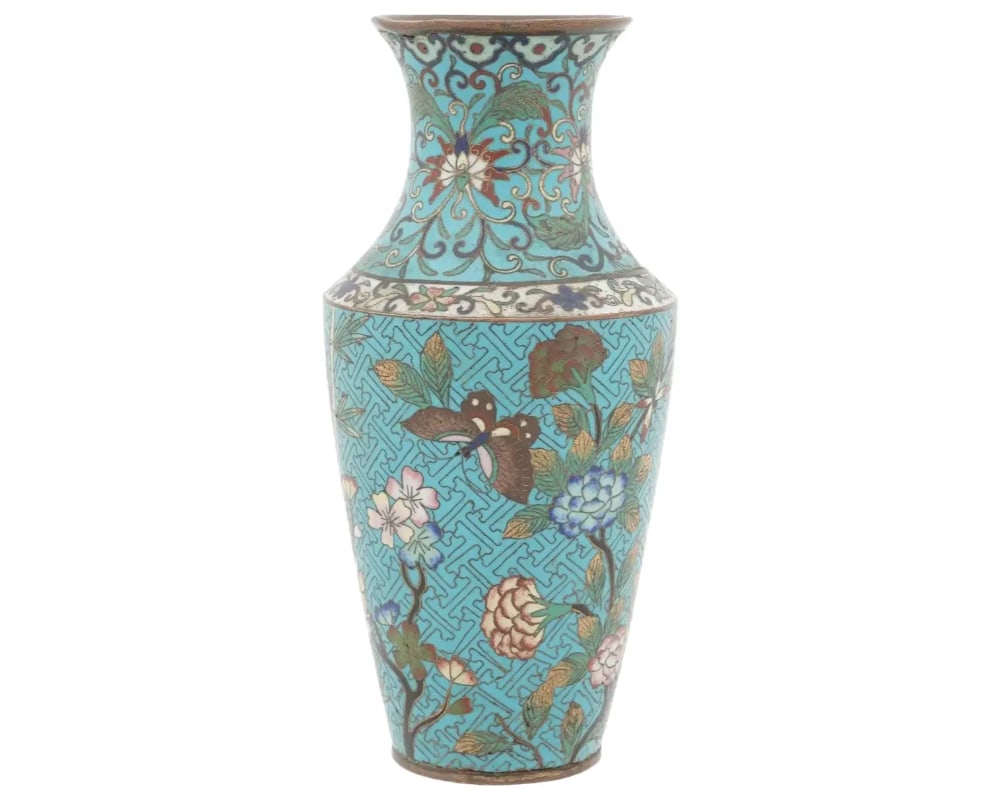High Quality Japanese Meiji Cloisonne Enamel Vase: A high quality antique Japanese Meiji era decorative brass and enamel vase. The exterior of the plate is adorned with polychrome floral, foliage, and butterfly patterns on a turquoise ground made in t