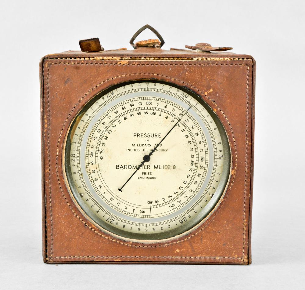 Friez hanging barometer in steel case with leather: Friez hanging barometer with dial marked "ML-012-B" in painted steel case with pressure chart on back, leather carrying case Details 7 in. x 7 in. x 4 in. Circa 1943 Details Steel case has some abrasi