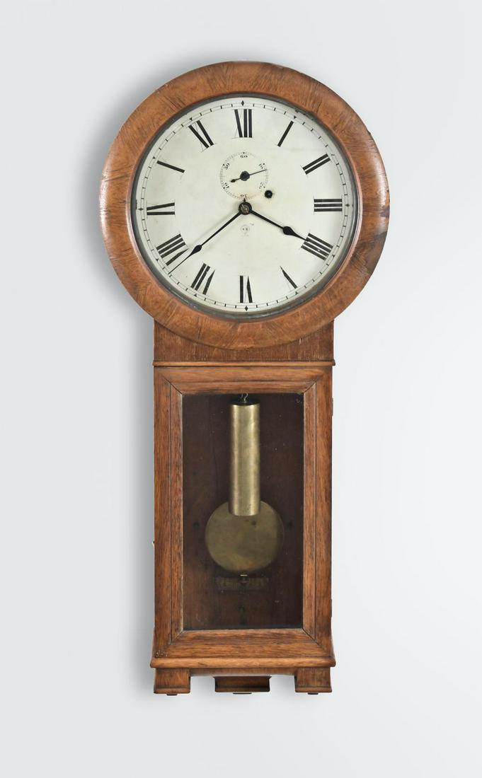 Seth Thomas Clock Co., Thomaston, Conn., "Regulator No.: Seth Thomas Clock Co., Thomaston, Conn., "Regulator No. 2", wall regulator, Oak and oak veneered case, painted iron dial, spade hands, 8 day, weight driven brass movement. Details 36.25in x 15.5in x 5