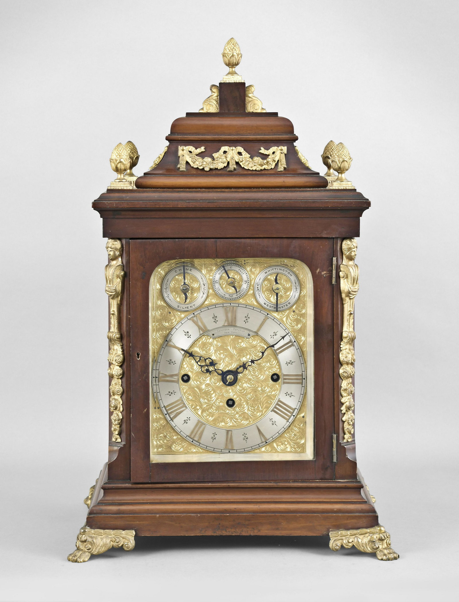 English, J.J. Elliott, Triple Fusee Bracket Clock: J.J. Elliott, London, for Camerden & Forster, New York, a mahogany quarter chiming bracket clock, the large, classic Georgian style case with brass caryatid corners above floral pendants, pineapple fi
