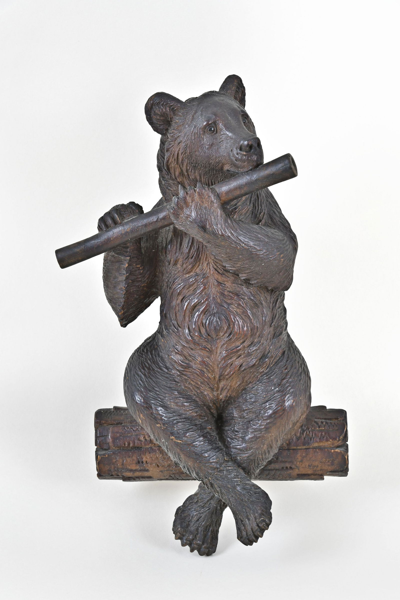 A whimsical Black Forest carved flute playing bear with (1 of 4)