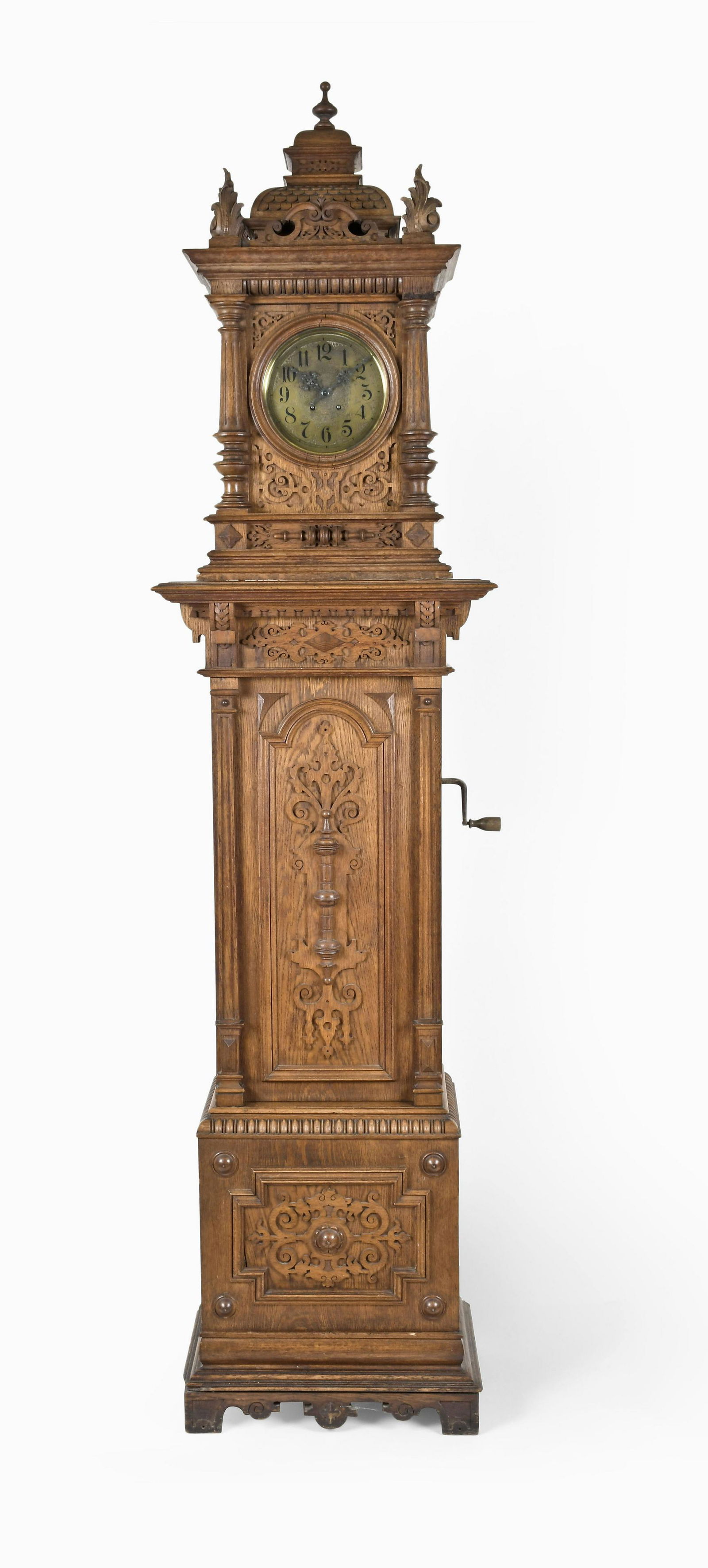 A German tall clock with Symphonion 13 5/8 inch disc music box and Lenzkirch movement: Plato & Co., Berlin, an early 20th century tall clock with Symphonion 13 5/8 inch disc music box and Lenzkirch movement, the oak case on a molded bracket base with storage compartment, the door with a