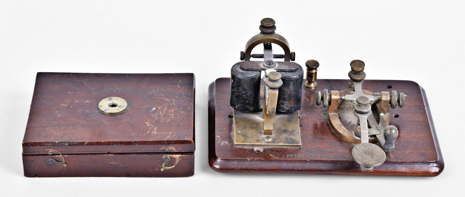 A 19th century pocket microscope and a Tillotson telegraph key with sounder (1 of 3)