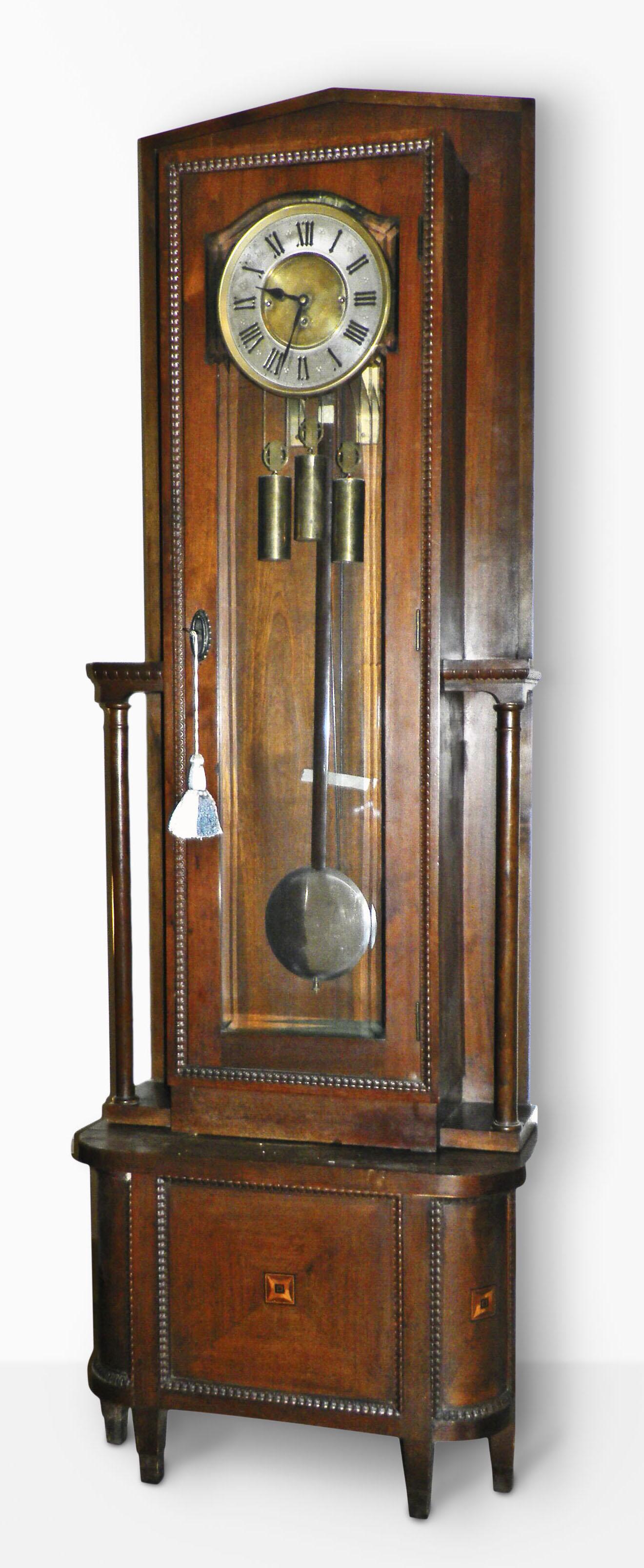 Austrian Grand Sonnerie Floor Clock: Austrian, Grand Sonnerie, three weight tall clock in an Art Deco style mahogany veneer case, the case edges with ripple molding and the door with heavily beveled glass, and rod strike movement is a qu