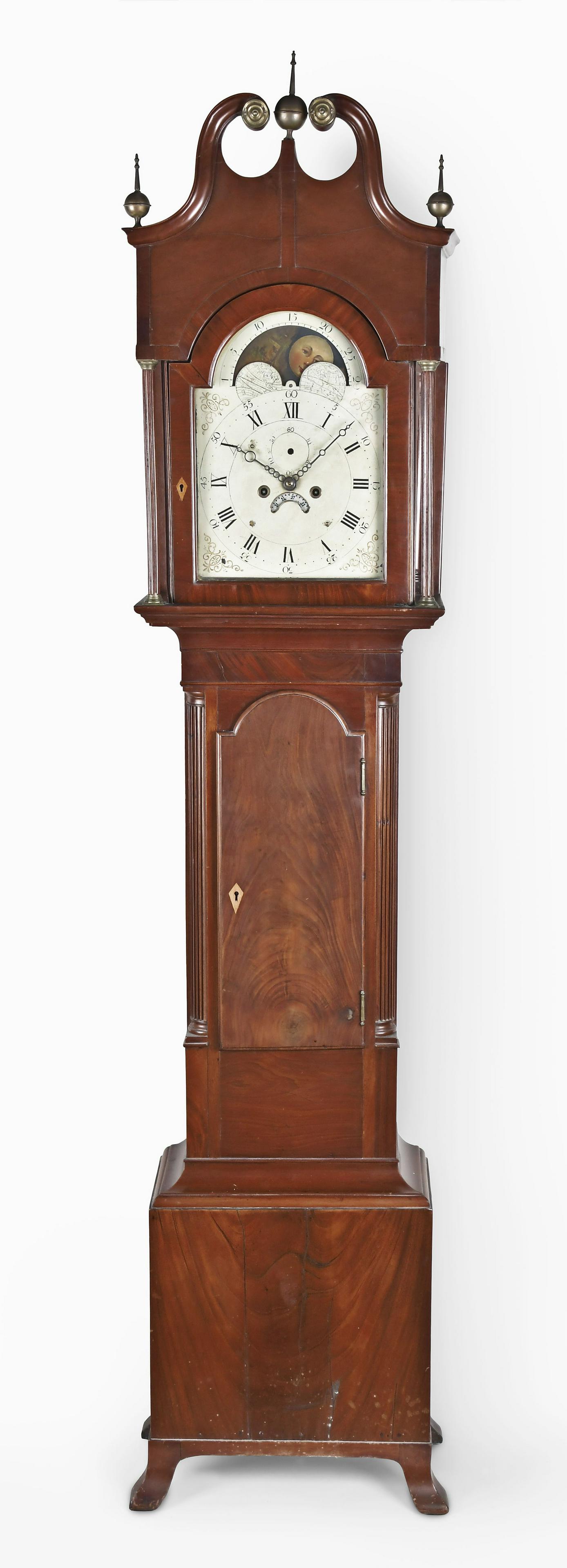American Tall Clock: American tall clock, mid-Atlantic region, in a mahogany and mahogany veneer case with broken arch top, brass rosettes and finials, fluted full columns flanking hood door over trunk with tombstone crot