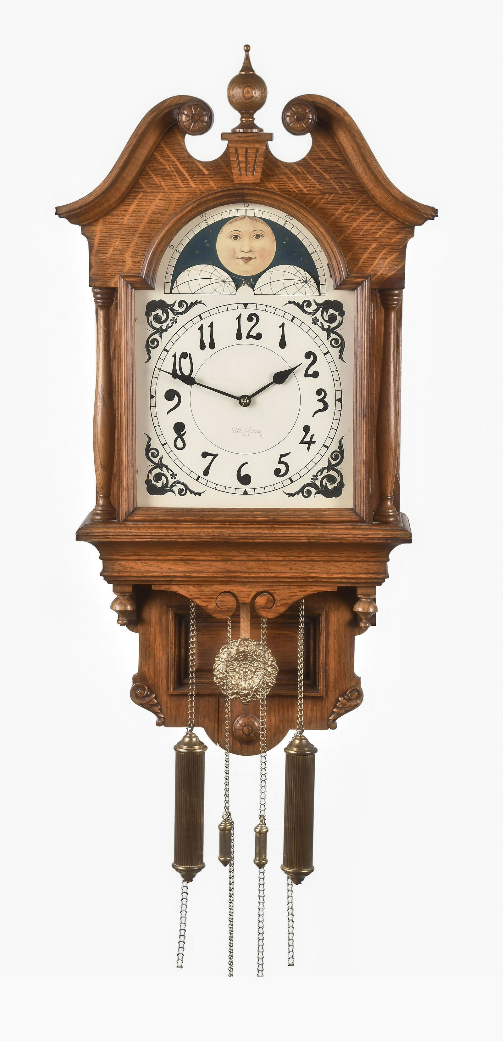 Seth Thomas Clock Co. Lunar hanging clock: Seth Thomas Clock Co., Thomaston, Conn., "Lunar" hanging clock in an oak case with arabic numeral painted metal dial, spade hands, 8 day, time and strike weight driven brass movement.