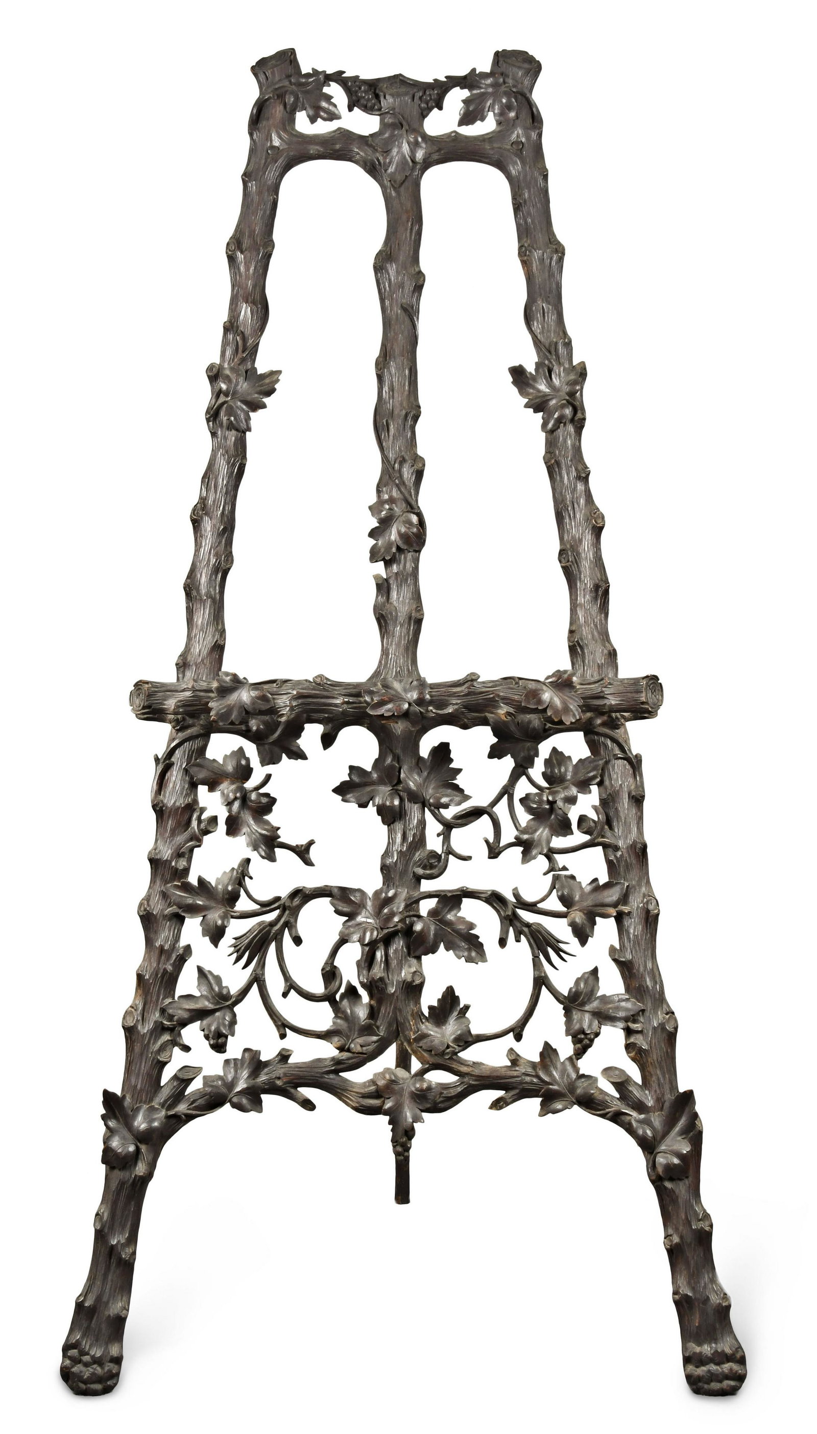 A very decorative Black Forest twig carved easel: Switzerland, a very decorative easel, the tripod with very well executed twig carved frame, the frame further enhanced with grape vines, leaves, and clusters