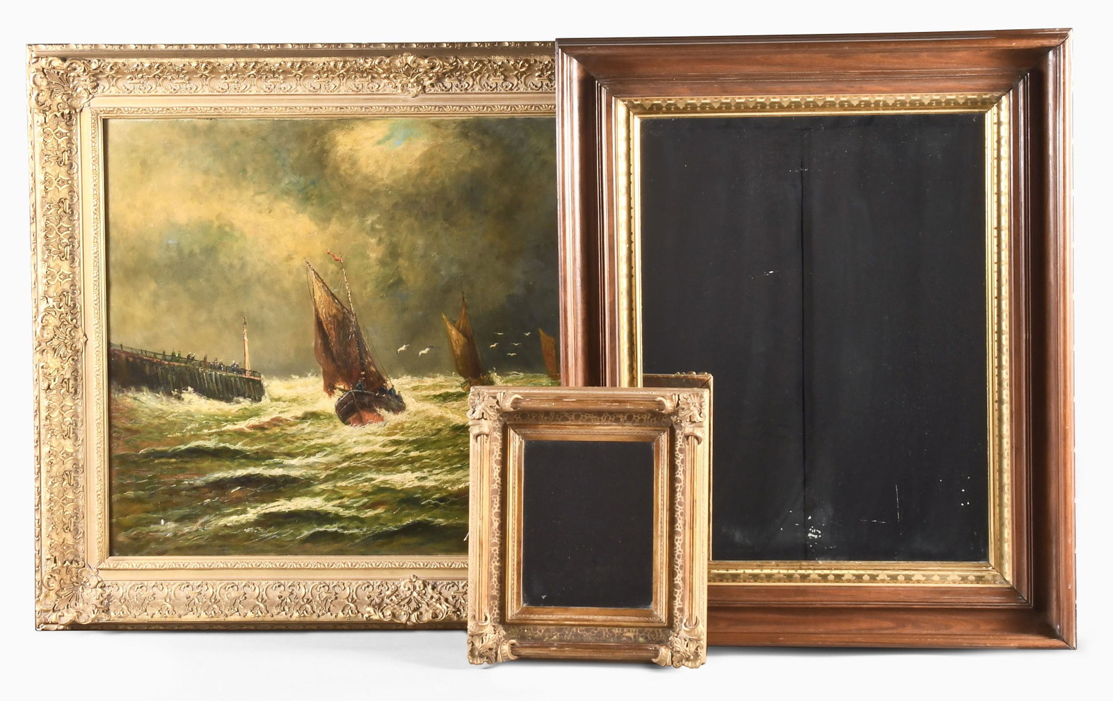 A large oil on canvas seascape signed B. Sylvan and two mirrors: A large oil on canvas seascape, "Stormy Day in the Northern Sea" signed B. Sylvan, the large canvas depicting three sailing vessels under gray skies, and on rough seas, a long wharf with spectators at