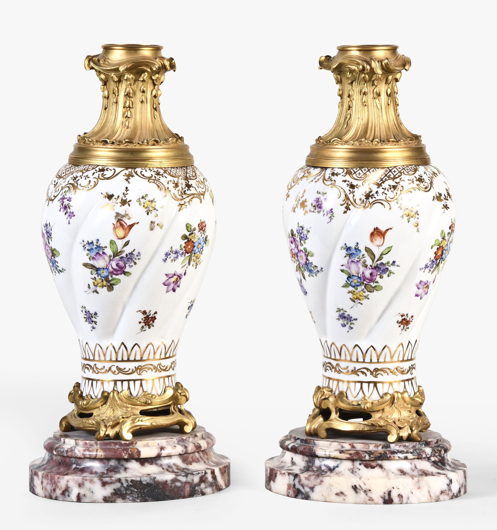 A very decorative pair of large ormolu mounted porcelain vases: France, a very decorative pair of large ormolu mounted porcelain vases, each on a round, molded marble base, the Paris porcelain style vases with polychrome floral and gold ornament, rococo, gilt, ope