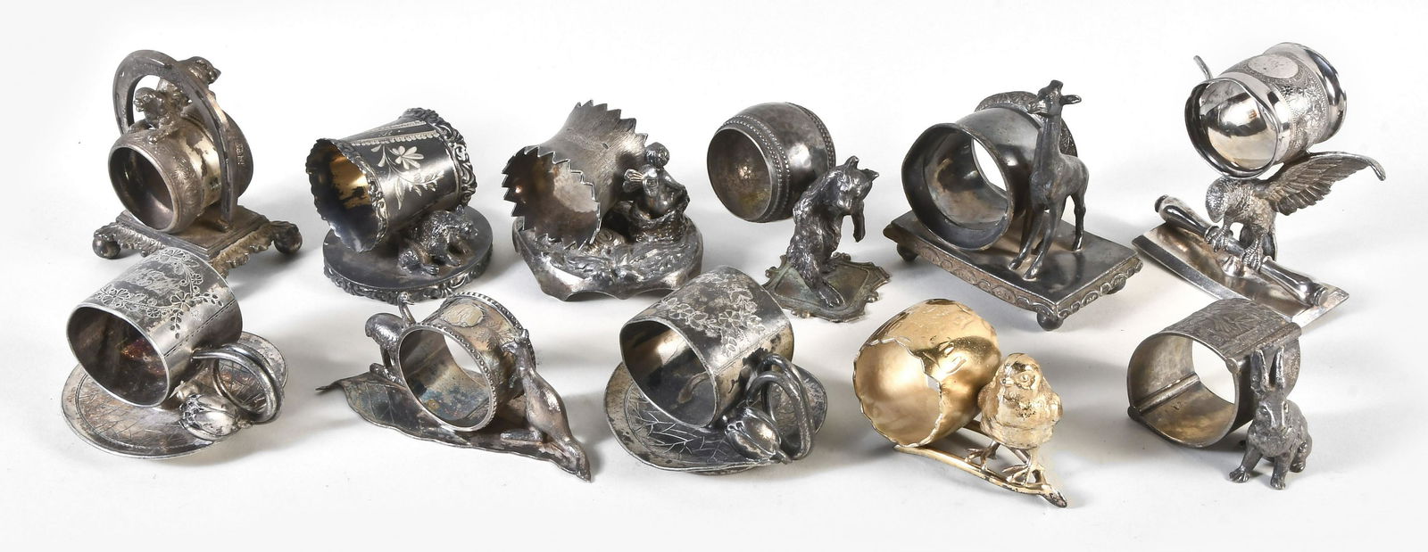 Large lot of napkin rings: 34 (Thirty-four) figural napkin rings including eight Meriden silver plate, Pairpoint, Rockford, Aurora, Darby, Cromwell, and others, together with two in glass and one carved bone